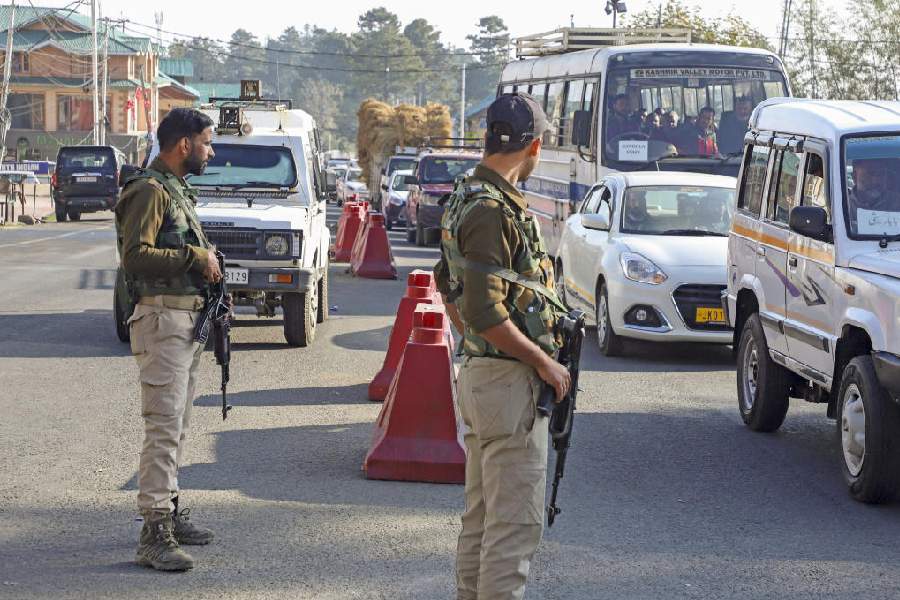 Security personnel stand guard on the Gulmarg-Botapathri road during a search operation on Friday. On Thursday evening, militants ambushed an army vehicle belonging to the 18 Rashtriya Rifles at Botapathri in the Nagin Valley, 10km uphill from the ski resort of Gulmarg and a few kilometres from the Line of Control. The area has not witnessed militant violence in a long time. PTI