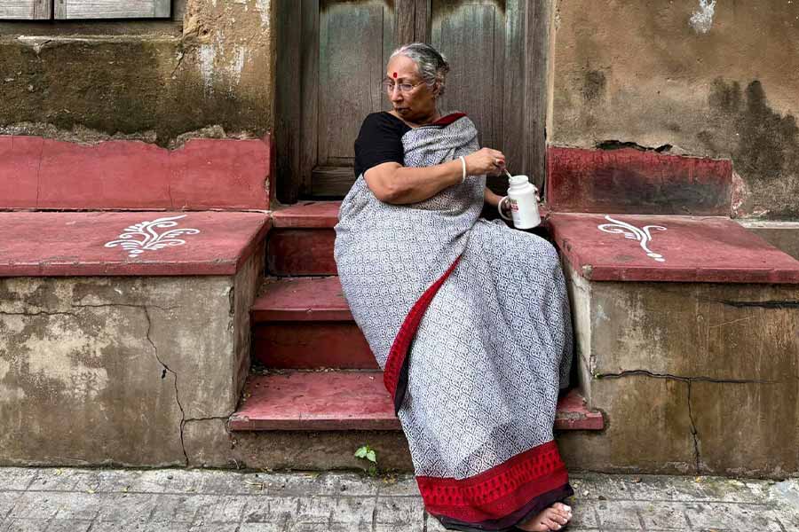 Ratnabali Ghosh’s ‘alpona’ livens up the red-cemented threshold of an old house in the Lake Market area