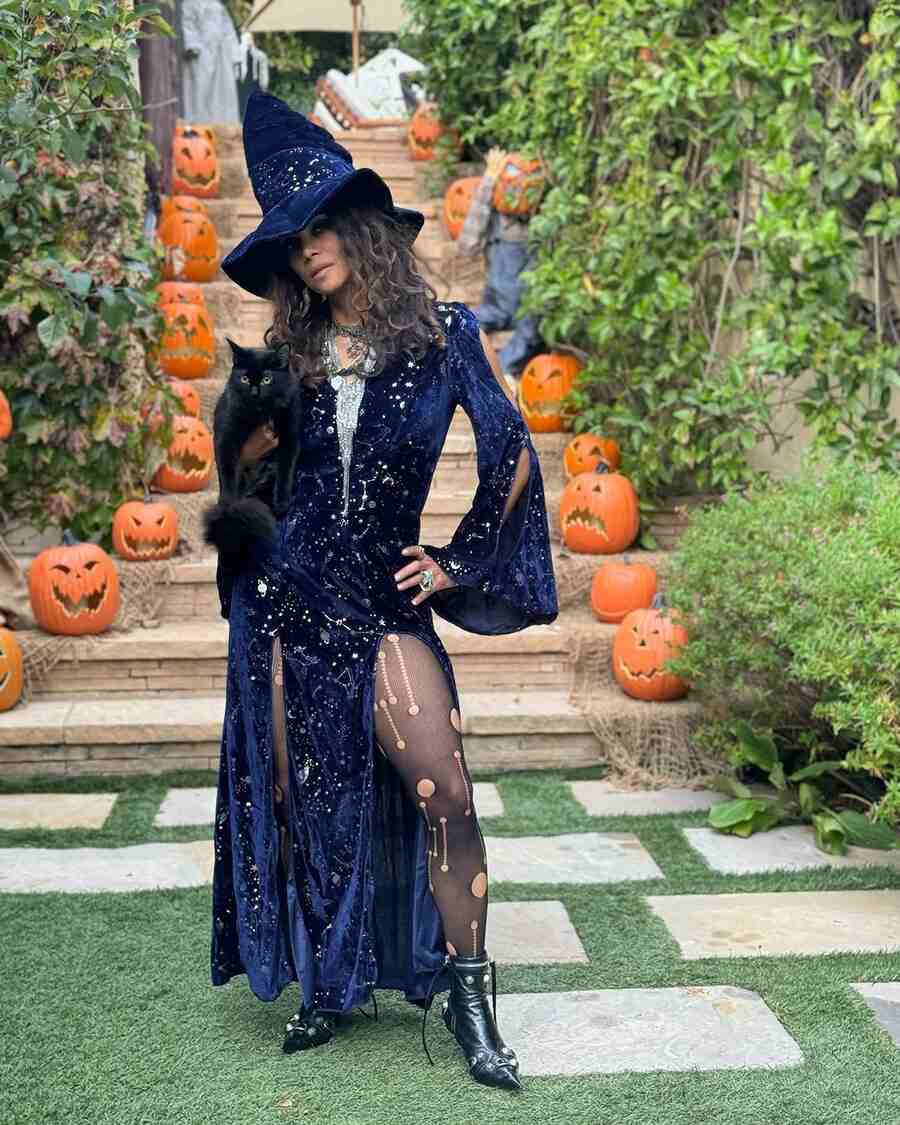 Halle Berry decked up as a witch in a blue slit-gown and a pointed hat, with her cat Coco in her arms, proving that she’s quite the Catwoman even after 20 years. “No need for tricks when me and my little black kitty are the treat! Happy International Black Cat Day y'all,” she captioned her pictures.