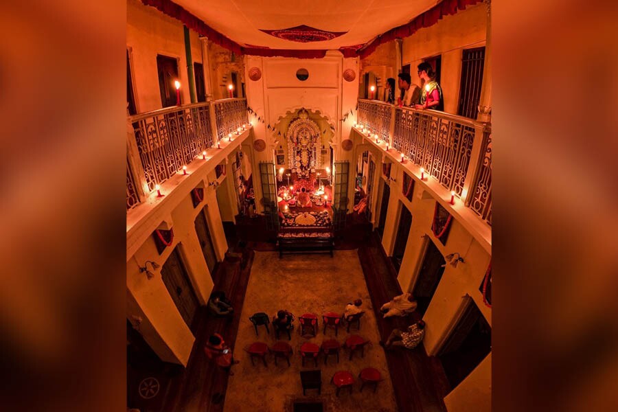 The courtyard in front of the long rectangular ‘thakur dalan’ is surrounded by balconies at the Bowbazar Haldar Bari. Kali Puja is conducted in the glow of candles and lamps only