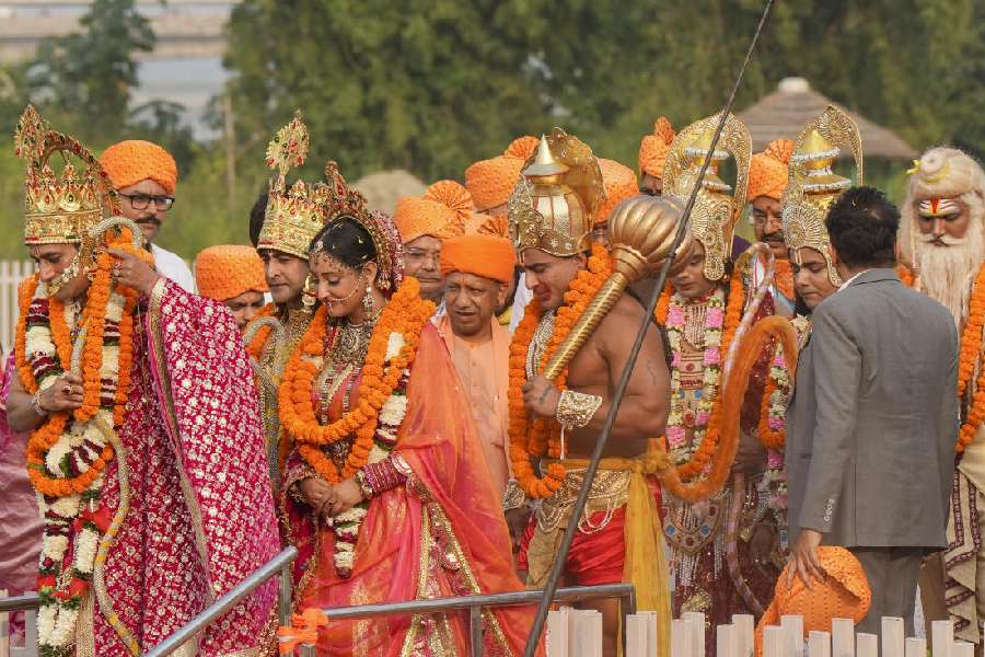 Adityanath with artists dressed as Lord Rama, Lord Lakshmana and Goddess Sita at the celebration. PTI