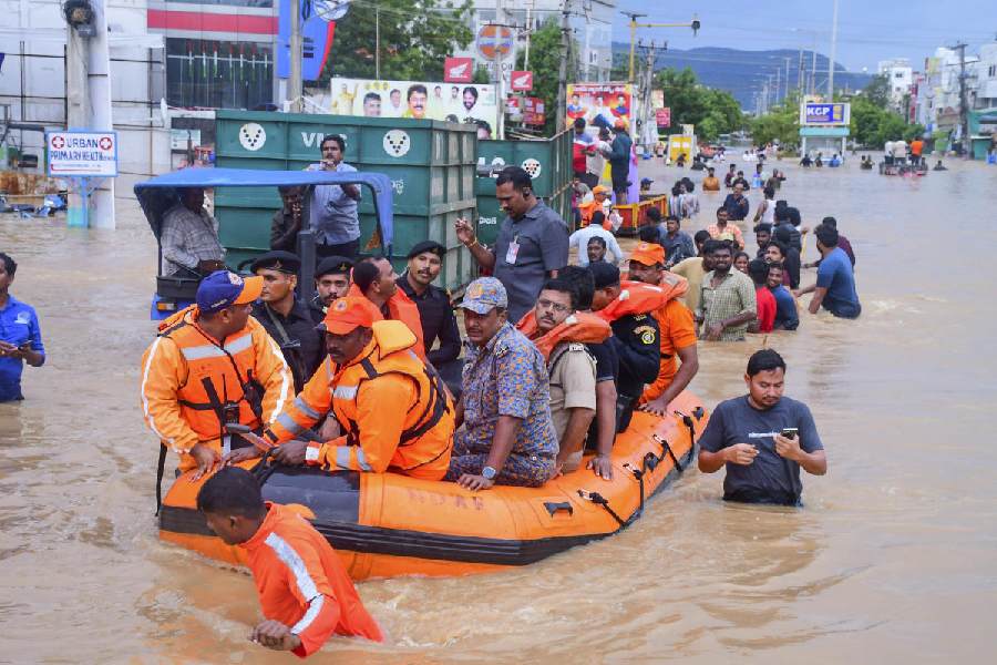Vijayawada City Police Commissioner IPS SV Rajasekhara Babu with others reviews the rescue operation at a flood-affected area after heavy rainfall, in Vijayawada.