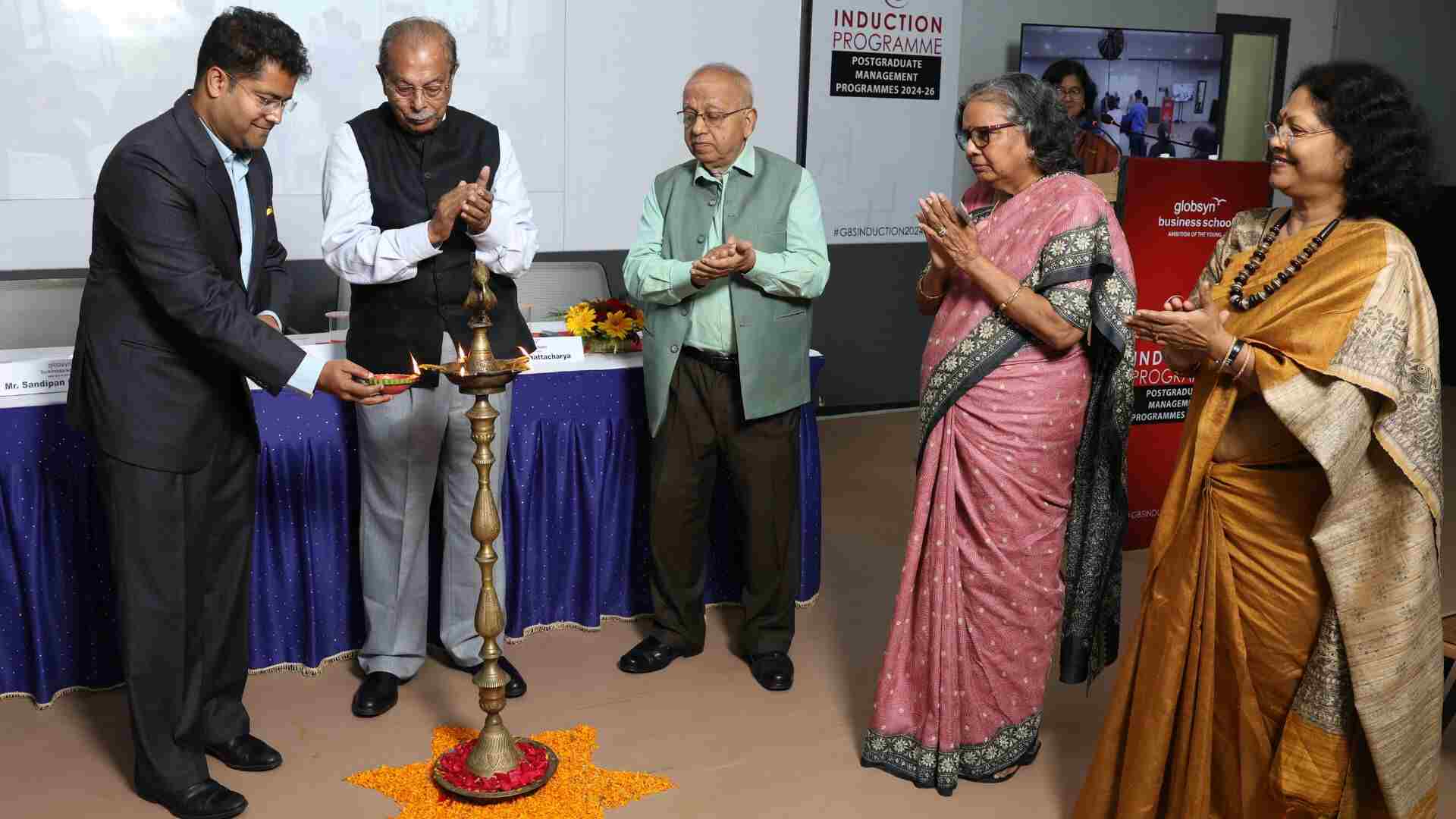 Ceremonial lighting of the lamp, marking an auspicious beginning to the Induction Programme for the students pursuing PGDM and PGDM – Business Analytics. (L to R) Rahul Dasgupta, Director & Trustee, GBS; Prof RC Bhattacharya, Vice Chairman, Globsyn Group; Sandipan Chakravorty, Chairman, Mjunction Services Limited and Governing Council Member, GBS; Suchitra Guha, Ex-Head – HR & IR, Tata Steel,  External HR Advisor – C-suite of Tata NYK, Singapore and Academic Council Member, GBS; Ranjana Dasgupta, Trustee, Globsyn Knowledge Foundation.