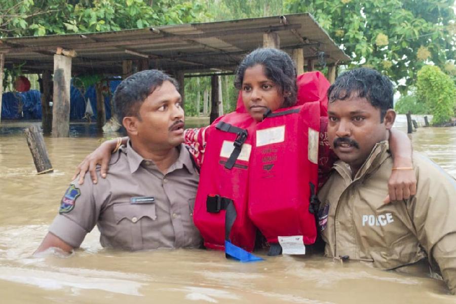 Rescue officials save a girl in a flood-affected area, in Bhadradri Kothagudem district, Telangana, Monday, Sept. 2, 2024. 