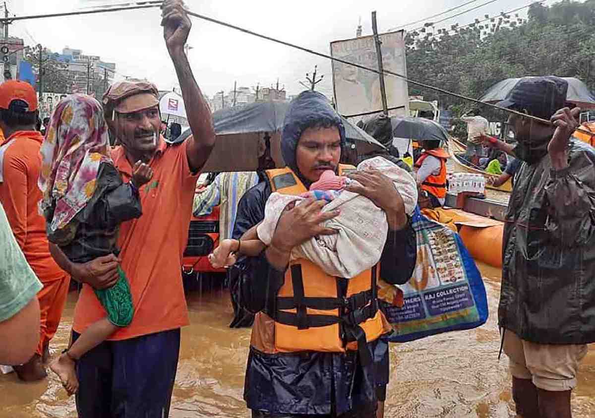 SDRF men rescue flood-hit people, in Ajit Singh Nagar, Vijayawada Monday, Sept. 2, 2024.