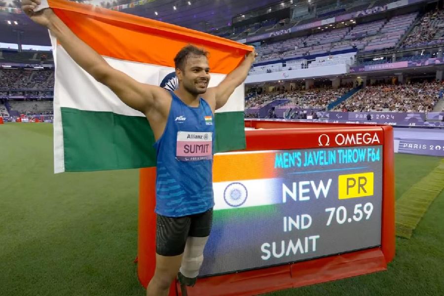 Sumit Antil poses for photographs after winning the gold medal in javelin throw F64 event in Paris Paralympics 2024, Monday, Sept. 3, 2024. Sumit secured gold with a 70.59 m throw.