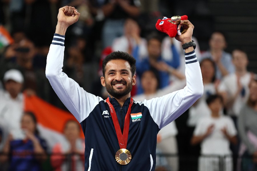 Nitesh Kumar celebrates after winning gold at Paralympics 2024.