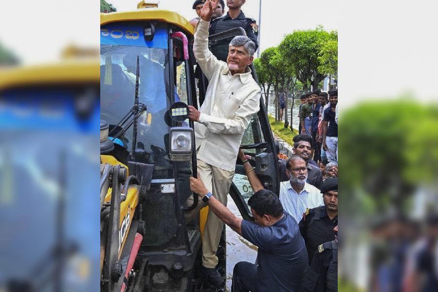 Chief Minister N Chandrababu Naidu travels on an excavator during his visit to the flood-affected areas, in Vijayawada