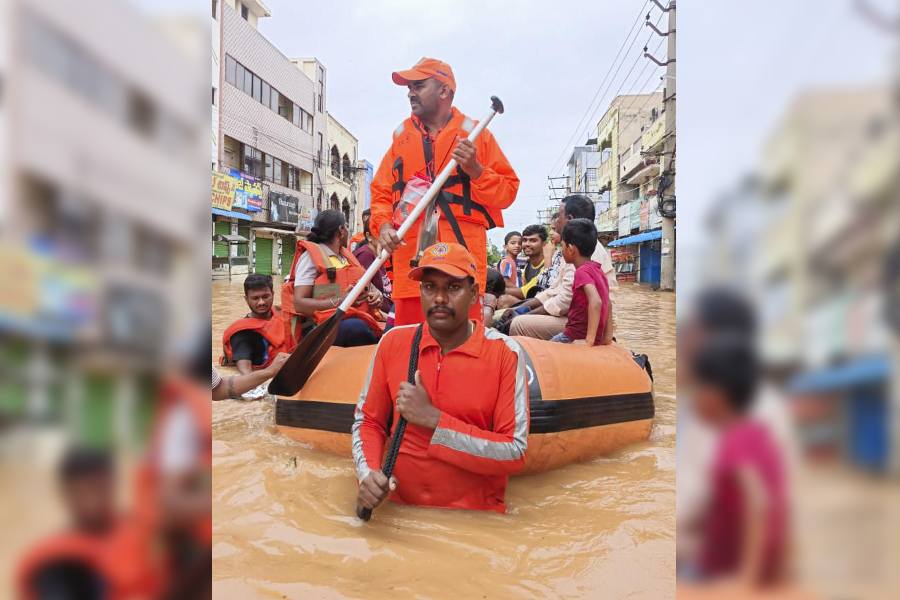 NDRF personnel evacuate people from a flood-affected area following heavy rainfall, in Vijayawada on 2nd Sept