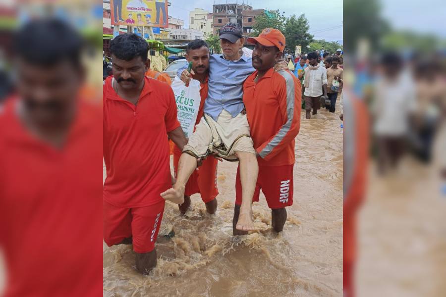 NDRF personnel evacuate people from a flood-affected area following heavy rainfall, in Vijayawadaon 2nd Sept