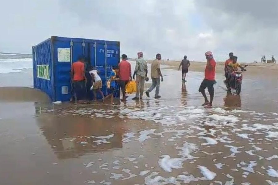 Residents take a look at the container.