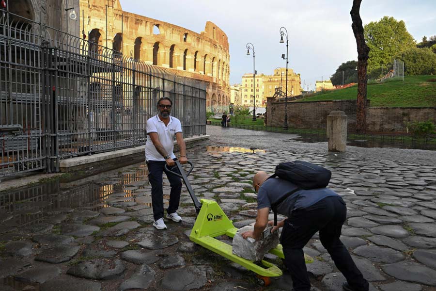 Colosseum Archaeological Park staff work to collect fragments of Constantine's Arch lying on the ground after lightning struck it during a storm in Rome, Italy September 3, 2024.