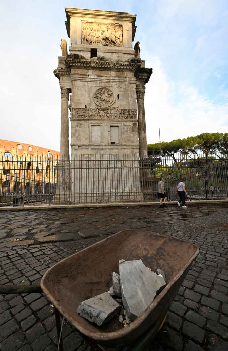 Fragments of Constantine's Arch are collected in a wheelbarrow after lightning struck it during a storm in Rome, Italy September 3, 2024.