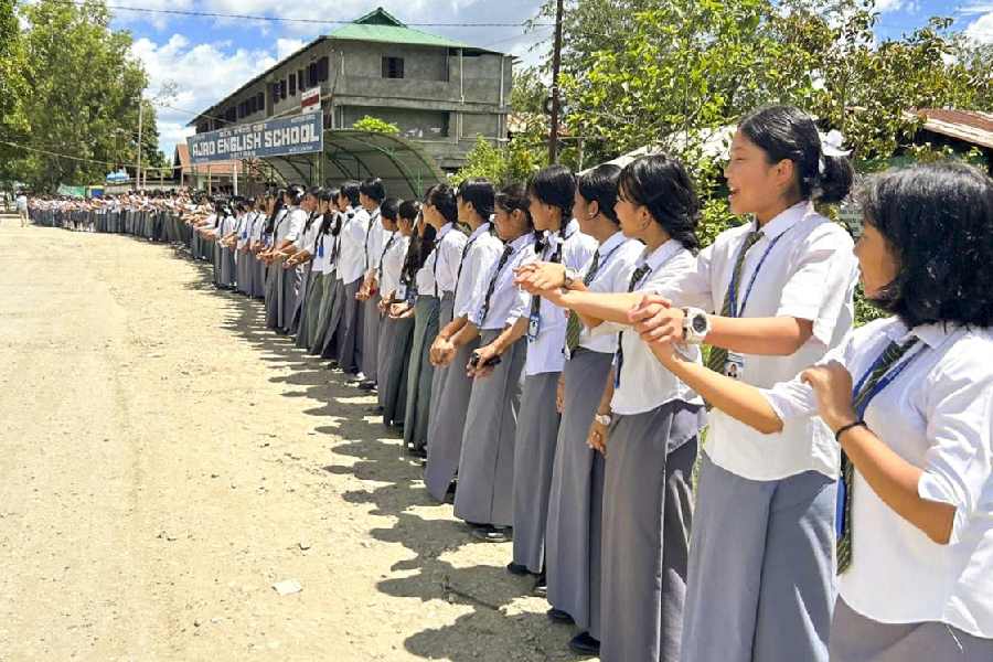 School students take part in a human chain rally on September 6, 2024 to protest against the recent drone and gun attacks in Manipur's Koutruk and Senjam Chirang that resulted in two civilian deaths and 12 injuries. 