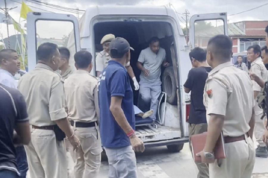 Police personnel shift injured to a hospital on September 2 after suspected Kuki militants attacked Koutruk villagers, in Imphal. 