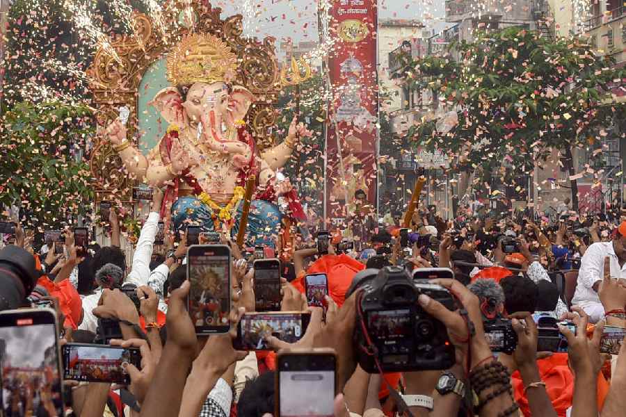 Devotees carry an idol of Lord Ganesha to pandal during a procession on the eve of the ‘Ganesh Chaturthi’ festival, in Nagpur.