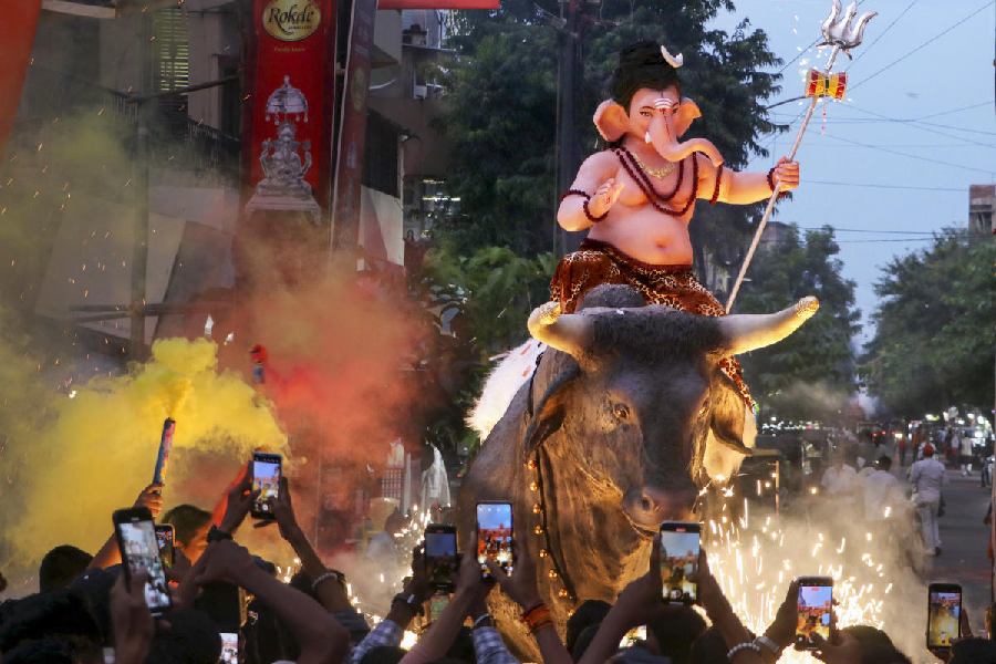 Devotees carry an idol of Lord Ganesha to pandal during a procession on the eve of the ‘Ganesh Chaturthi’ festival, in Nagpur.