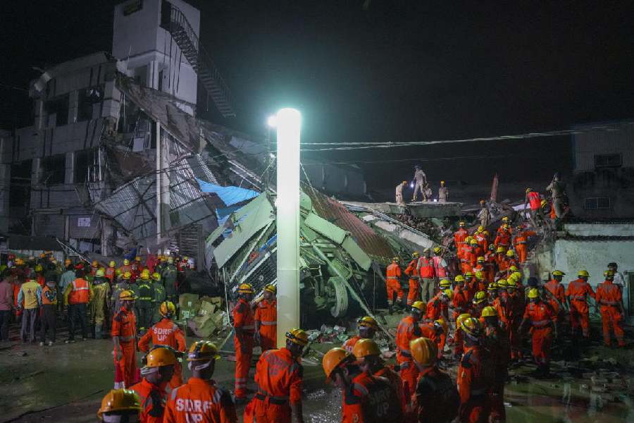 SDRF personnel conduct a rescue operation after a three-storey building collapsed, at Transport Nagar area in Lucknow, Saturday, Sept. 7, 2024.