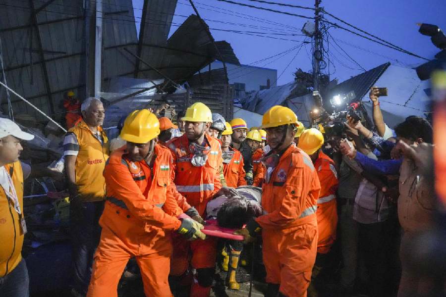 An injured being rescued after a three-storey building collapsed, crushing a truck under its debris, at Transport Nagar area in Lucknow, Saturday, Sept. 7, 2024.