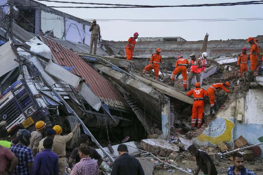 SDRF personnel conduct rescue operation after a three-storey building collapsed, crushing a truck under its debris, at Transport Nagar area in Lucknow, Saturday, Sept. 7, 2024.