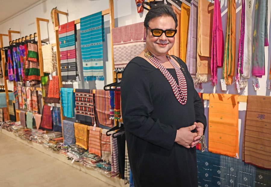 Sujoy Prasad Chatterjee wears an ornate ruby and pearl neckpiece from Mireya Jewels at the Mireya Jewels exhibition at Art in Life