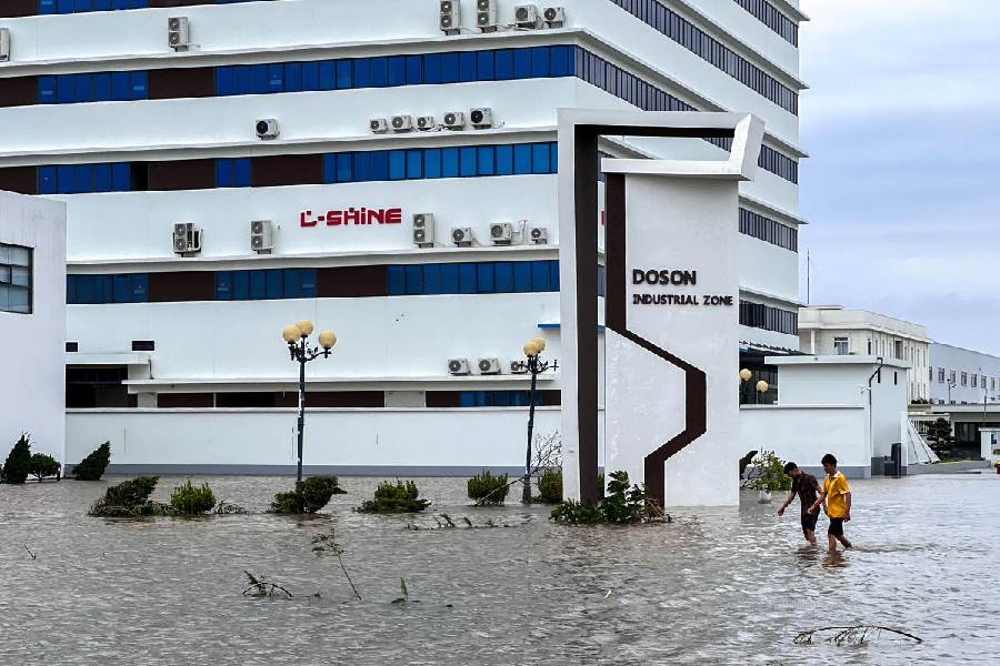 People wade through a flooded street following the impact of Typhoon Yagi, Hai Phong, Vietnam.