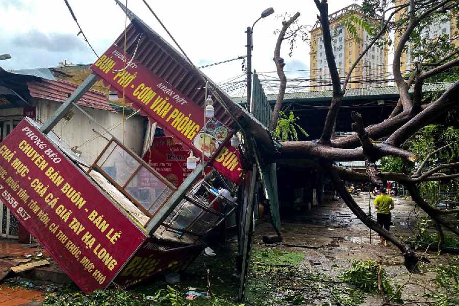 A man walks past a devastated area following the impact of Typhoon Yagi, in Hanoi, Vietnam.