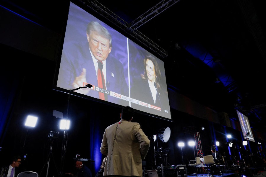 A screen displays the presidential debate hosted by ABC between Republican presidential nominee, former U.S. President Donald Trump and Democratic presidential nominee, U.S. Vice President Kamala Harris in Philadelphia, Pennsylvania, U.S.