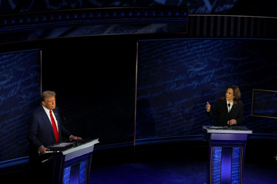 Democratic presidential nominee, U.S. Vice President Kamala Harris speaks during a presidential debate hosted by ABC as Republican presidential nominee, former U.S. President Donald Trump listens, in Philadelphia, Pennsylvania, U.S.