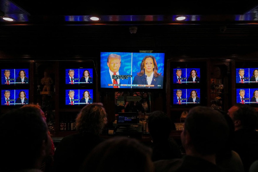 People watch the presidential debate between Republican presidential nominee and former U.S. President Donald Trump and Democratic presidential nominee and U.S. Vice President Kamala Harris at a watch party hosted by the New York Young Republican Club, in New York City, U.S.