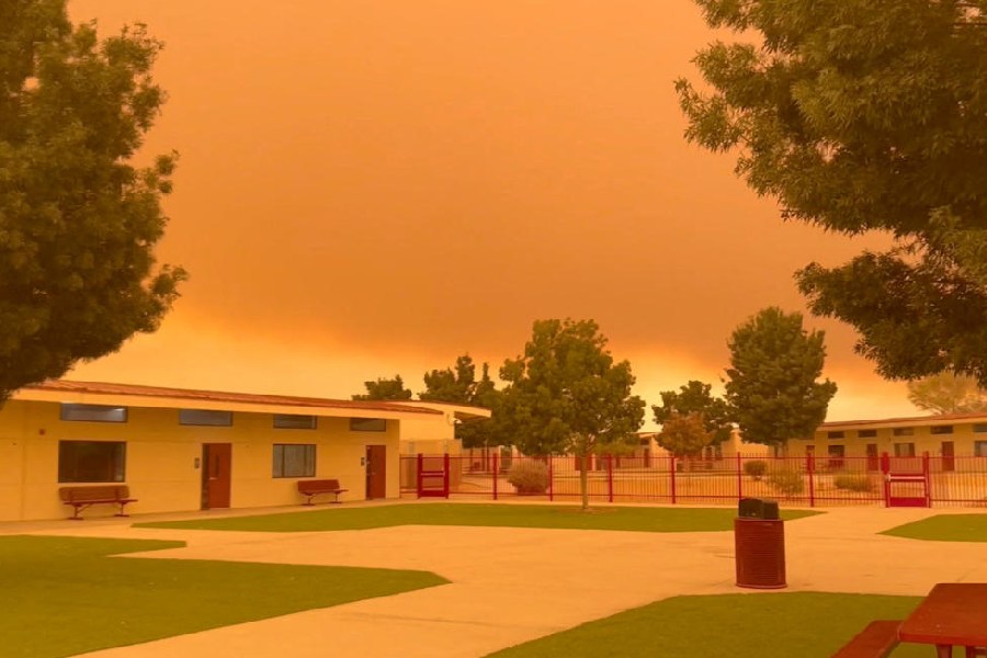 Smoke from Line Fire and Bridge Fire casts an orange hue across the sky, in Oro Grande, California, U.S.