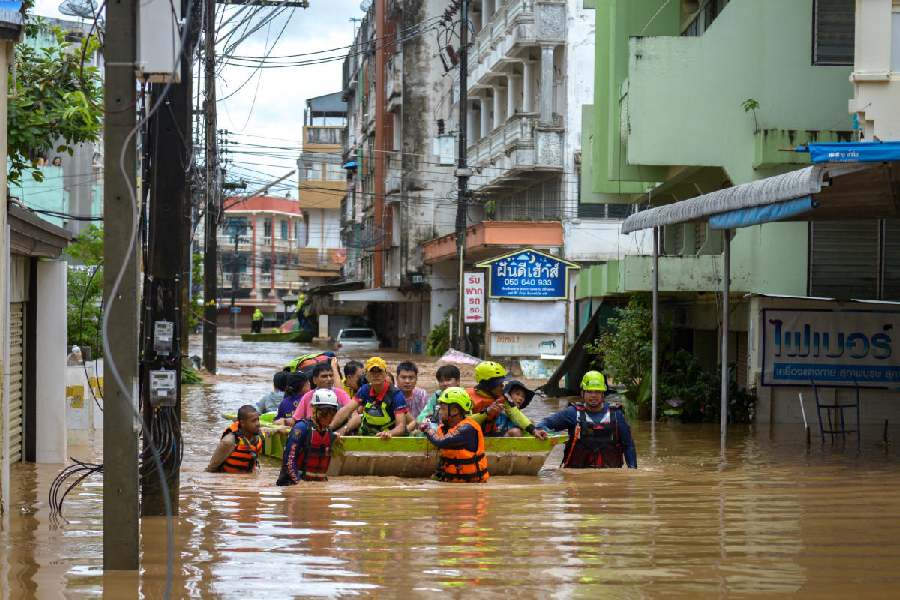 Rescue workers help stranded people from a flooded area at the border town of Mae Sai, following the impact of Typhoon Yagi, in the northern province of Chiang Rai, Thailand.