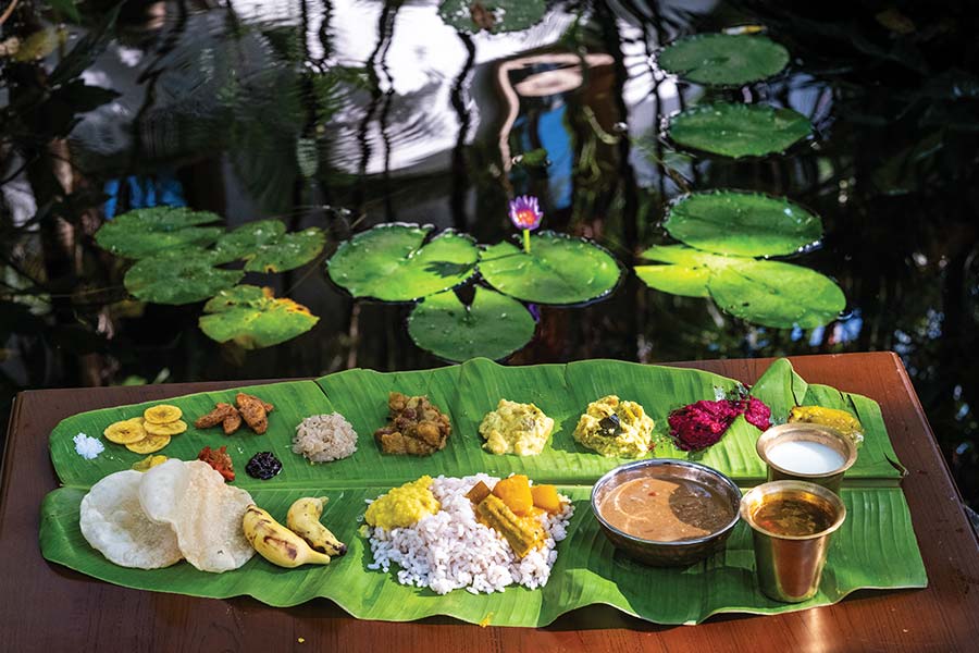 A traditional Nair Onam 'sadya' served on a banana leaf, featured in the book
