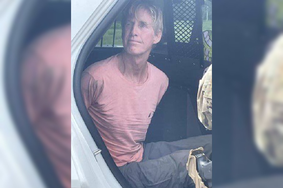 Ryan Routh in the back of a police car at Trump International Golf Course after his assassination attempt on former President Trump.