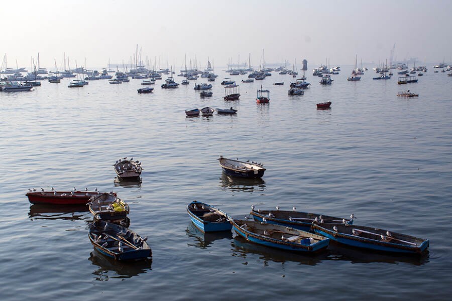 An assortment of boats and vessels at the harbour as viewed from the Gateway of India complex