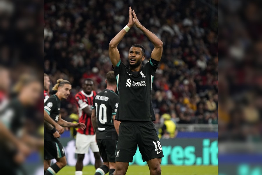 Cody Gakpo celebrates after assisting Dominik Szobozslai for Liverpool's third goal for the night.