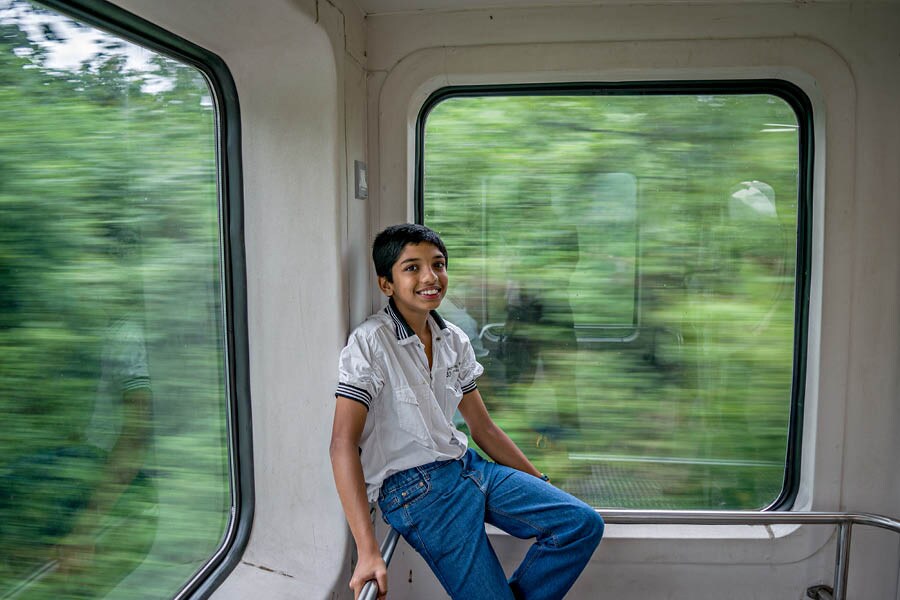 A school boy enjoys his ride on the Araku AC Tourist Passenger — India’s first vistadome coach train in the Eastern Ghats Shutterstock