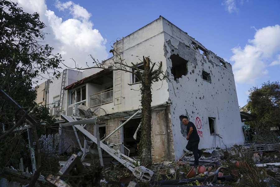 Israeli security forces work at a house hit by a rocket fired from Lebanon, in Kiryat Bialik, northern Israel, on Sept. 22, 2024.