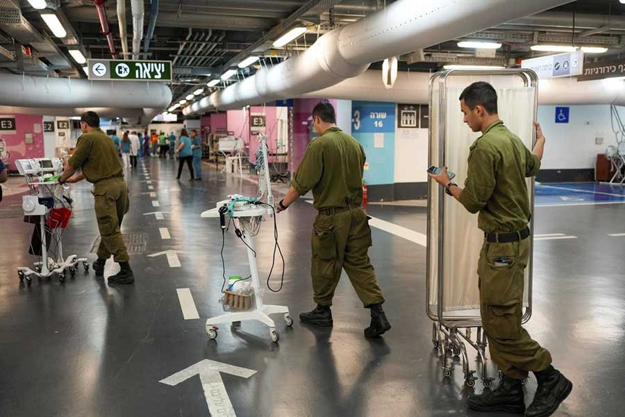 Hospital staff and soldiers move patients and equipment to the underground ward at Rambam medical center as fighting escalates between Israel and the Lebanese militant group Hezbollah on Sept. 22, 2024. 