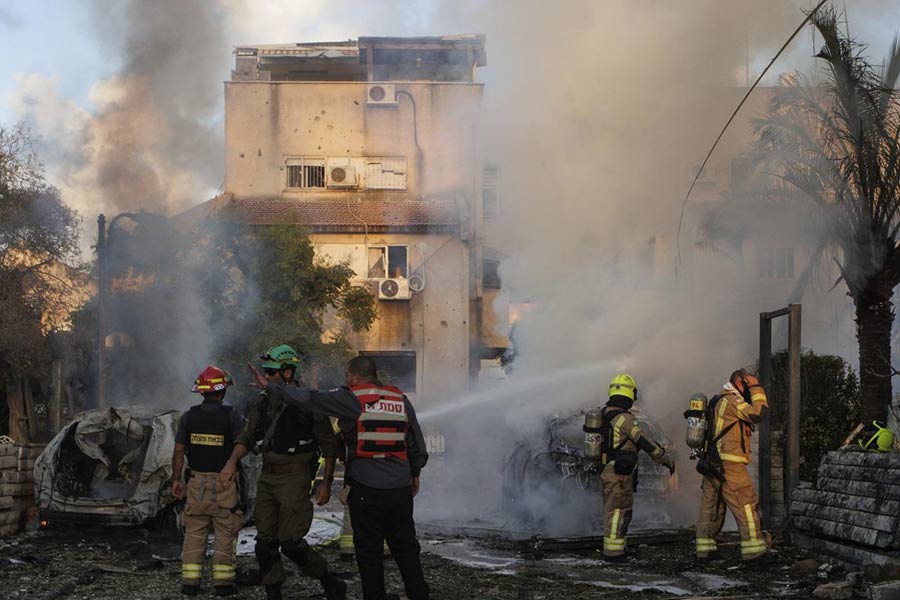 Israeli security and rescue forces work at the site hit by a rocket fired from Lebanon, in Kiryat Bialik, northern Israel, on Sept. 22, 2024. 