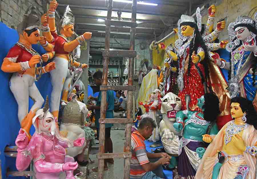 Just two weeks left for Durga Puja to start, an artisan races against time applying the final coat of paint on idols at Kumartuli
