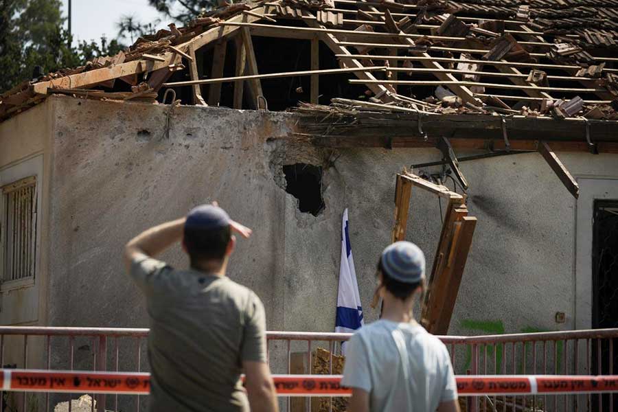 People look at a damaged house that was hit by a rocket fired from Lebanon, near Safed, northern Israel, on Sept. 25, 2024. 