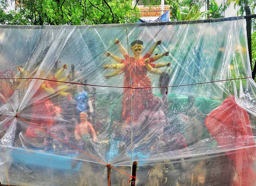 Durga and her family get some rain cover in Atghara, Baruipur