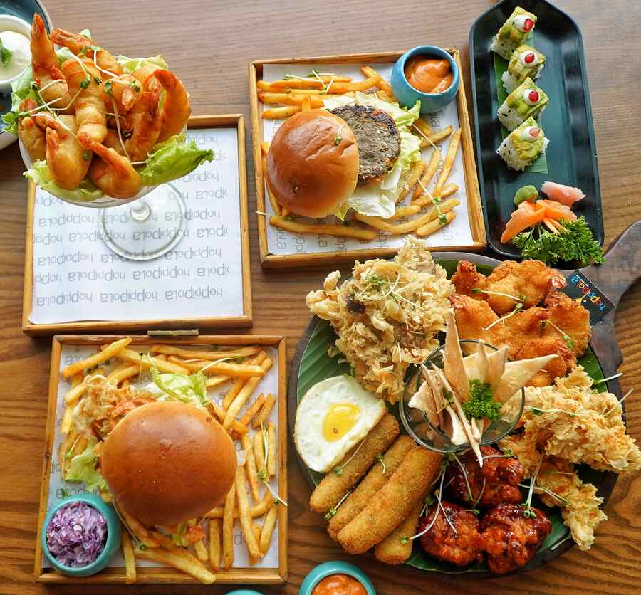 Hoppipola, on the fourth floor of Acropolis Mall, has reopened after three months with a new look and a new menu. The mall, and the restopub, were shut following a fire in June. The mall reopened on August 3, and the Kasba hotspot is now all ready to welcome back guests. My Kolkata tried some of the new items on the menu such as (in picture, clockwise from top left) Dynamite Prawns, Spicy Peruvian Potato Burger, Cream Cheese Avocado Sushi, Hoppi Sampler Platter and the OG Smashed Lamb Burger 