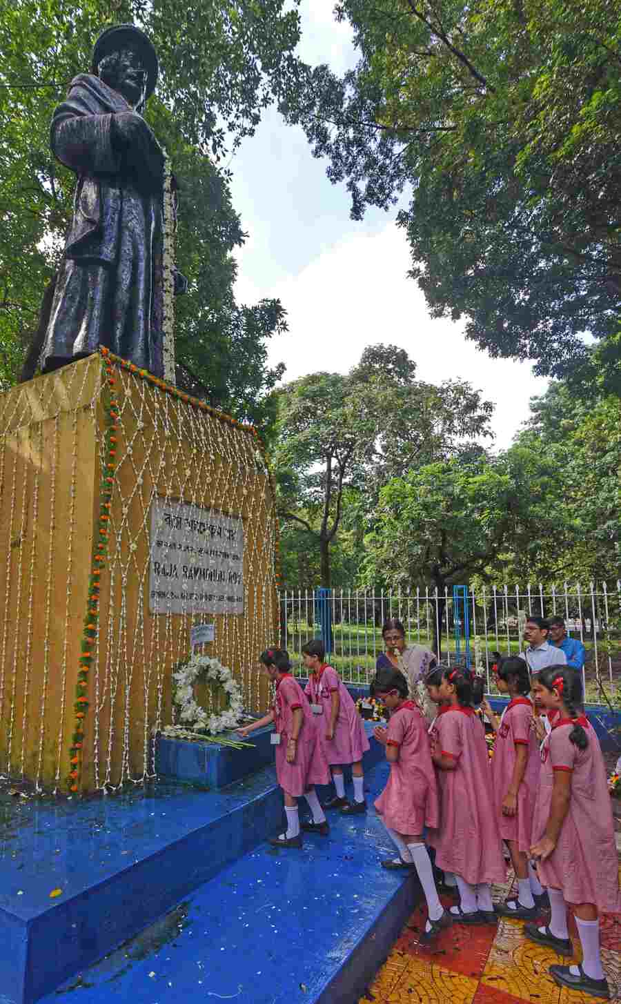 Students of Brahmo Balika Shikshalaya Montessori section offer tuberoses at the statue of Raja Ram Mohun Roy at the Maidan on  his death anniversary on Friday