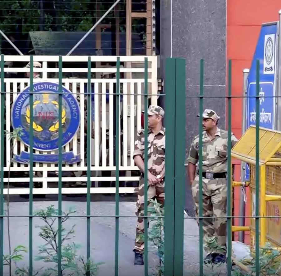 Security personnel stand guard at the National Investigation Agency (NIA) headquarters, in New Delhi, Friday, Apr. 11, 2025.