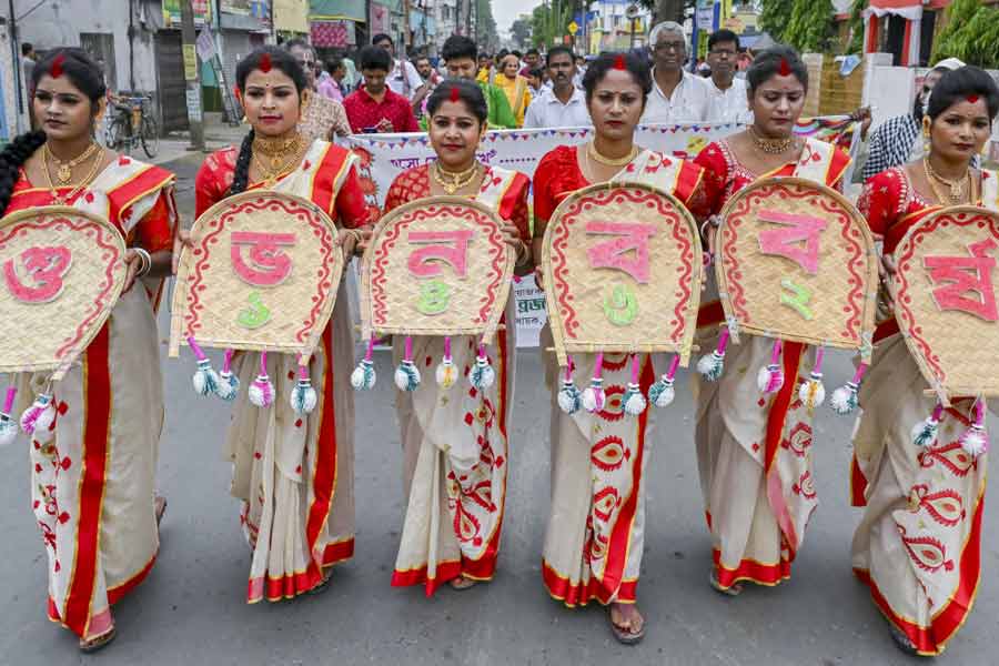 Women wearing traditional Bengali-styled saris hold 'Kulos' amid Bengali New Year celebrations, in Nadia.