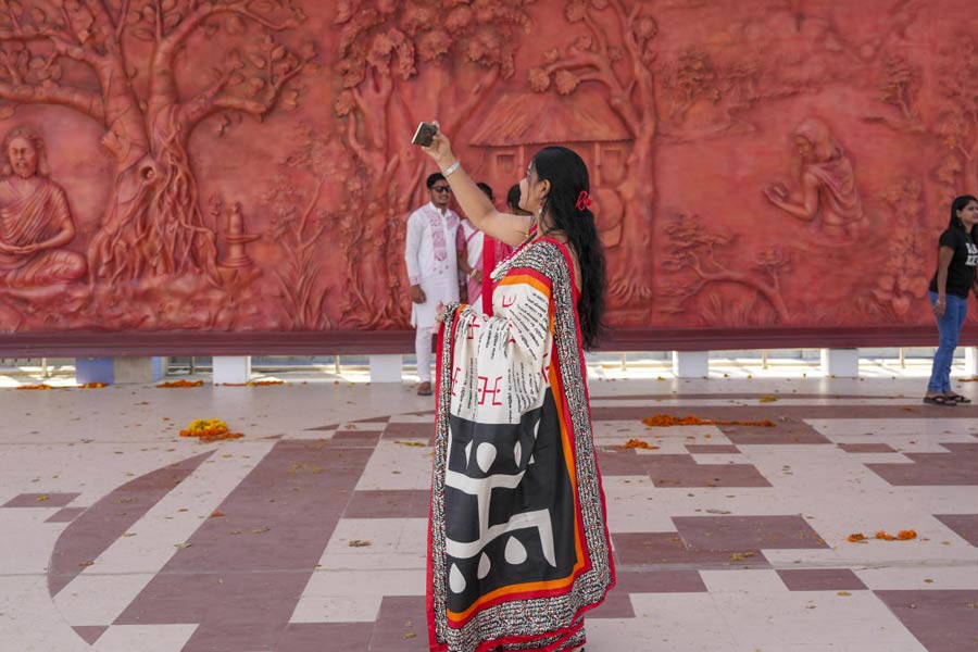 A woman clicks selfies at Kalighat's skywalk on Bengali New Year's day, in Kolkata.
