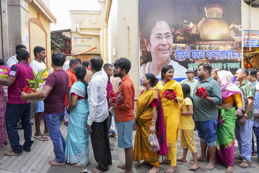 People wait in a queue to offer prayers at Kali temple on the Bengali New Year's day, at Kalighat in Kolkata.