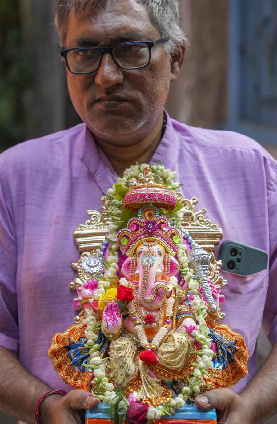 A man carries an idol of Lord Ganesh on 'Poila Boisakh' or Bengali New Year's day, in Kolkata.